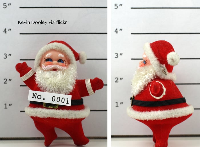 A santa doll getting his picture taken