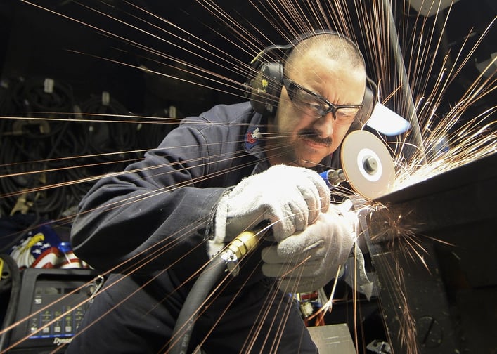 Steel worker using a saw